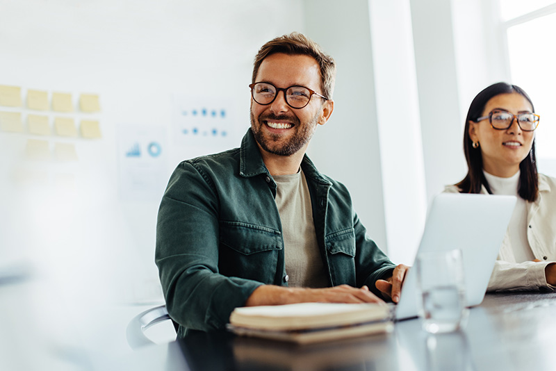 A man smiles while working.